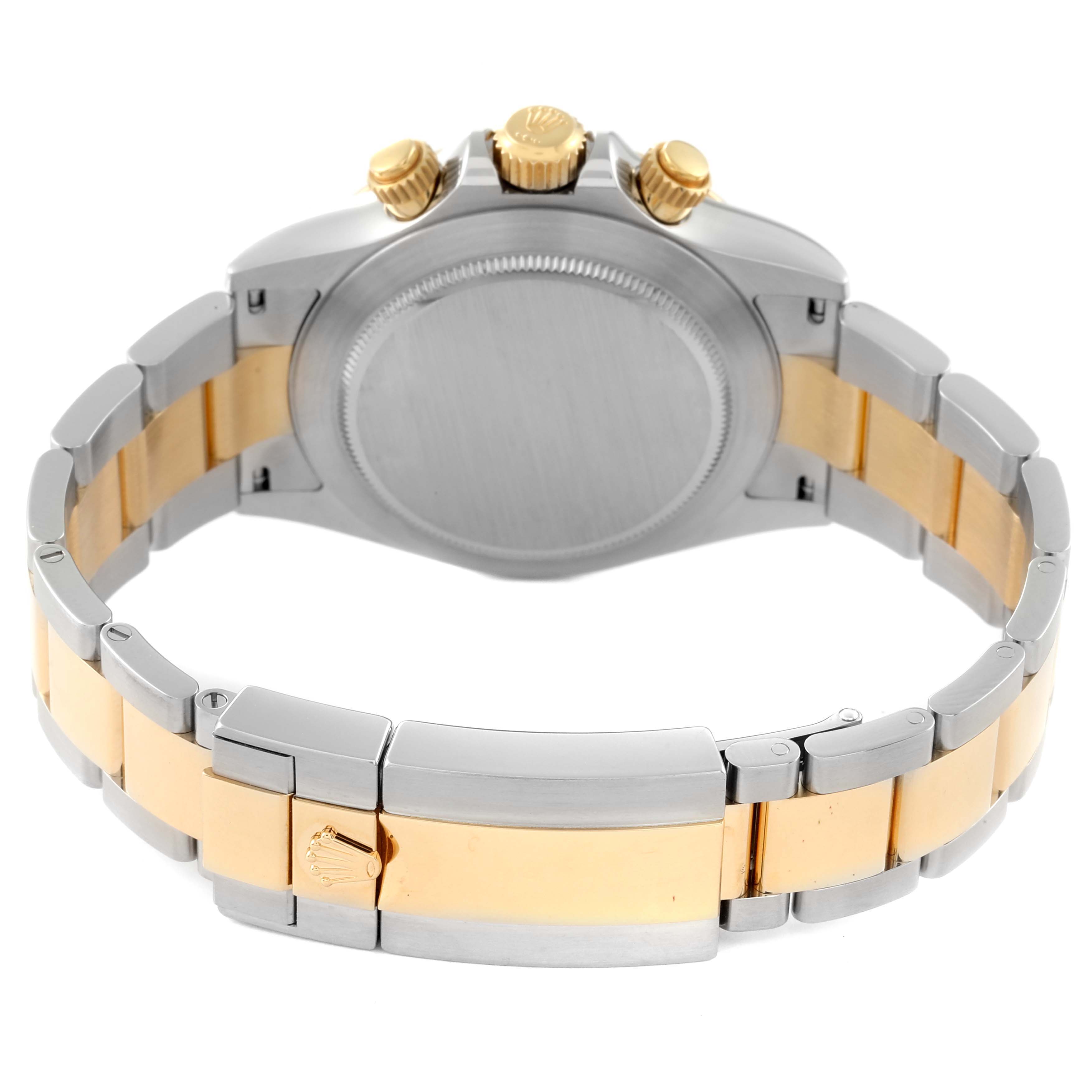 The image shows the back view of a Rolex Daytona 116503 Men's Steel and Gold (two tone) White Dial 116503 Men's Steel and Gold (two tone) White Dial, highlighting its case, screw-down pushers, and two-tone bracelet.