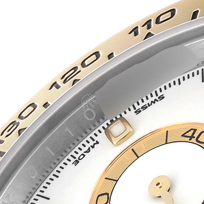 The image shows a close-up of the bezel, tachymeter scale, and part of the dial of a Rolex Daytona 116503 Men's Steel and Gold (two tone) White Dial 116503 Men's Steel and Gold (two tone) White Dial watch.