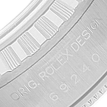 This close-up image shows the engraved serial and model numbers on the inner bezel of a Rolex Date 69240 Women's Stainless Steel Blue Dial 69240 Women's Stainless Steel Blue Dial watch.