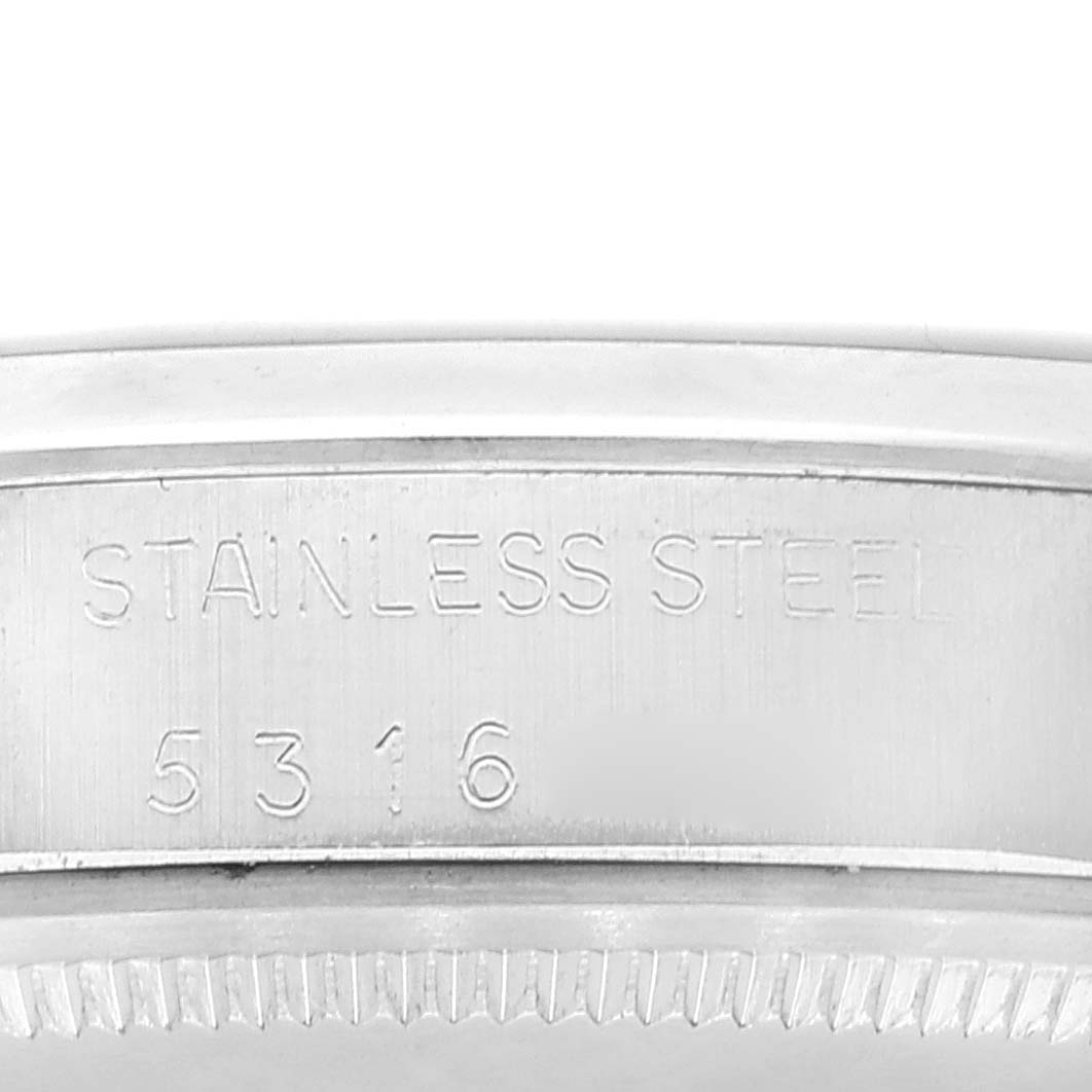 This image shows the side view of the case back of a Rolex Vintage Collection 1500 Men's Stainless Steel Silver Dial 1500 Men's Stainless Steel Silver Dial model, featuring its stainless steel engraving and serial number.