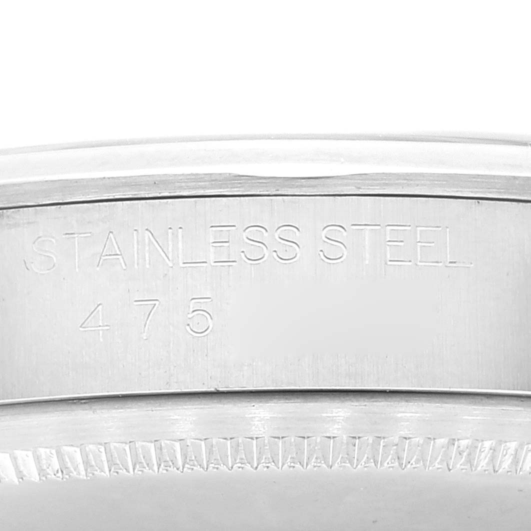 This image shows a close-up of the stainless steel bezel of a Rolex Date 1500 Men's Stainless Steel Silver Dial 1500 Men's Stainless Steel Silver Dial model watch.