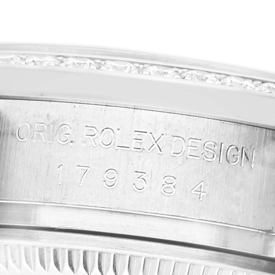 The image shows a close-up side view of the Rolex Datejust 179384 Women's Stainless Steel Pink Dial model, highlighting the engraved serial number.