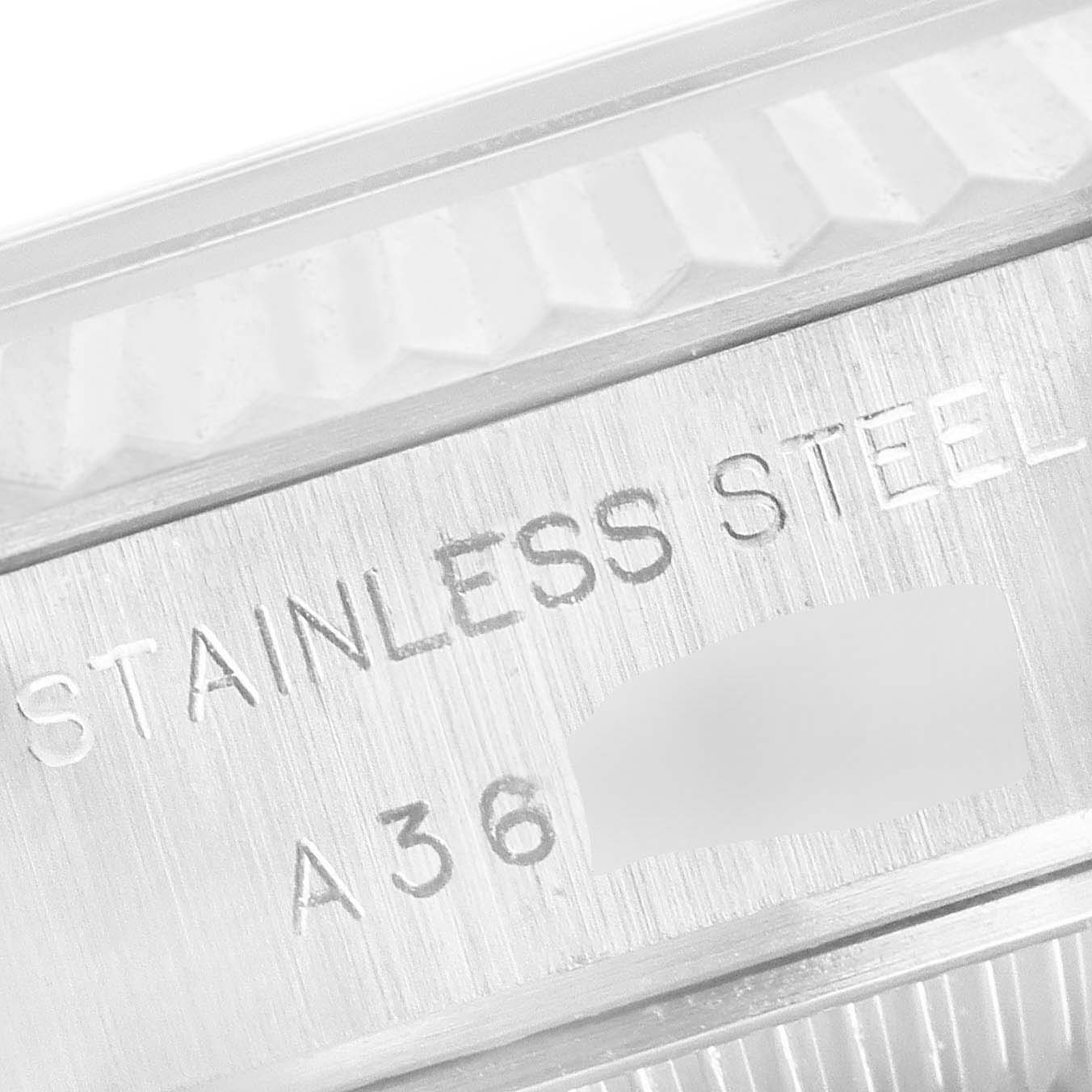 This close-up image shows the case of a Rolex Datejust 79174 Women
s Stainless Steel Black Dial 79174 Women
s Stainless Steel Black Dial watch, highlighting the "STAINLESS STEEL" engraving.