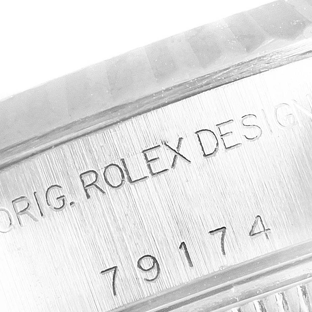 The image displays the engraved reference number and "ROLEX DESIGN" on the case side of a Rolex Datejust 79174 Women
s Stainless Steel Black Dial 79174 Women
s Stainless Steel Black Dial watch.