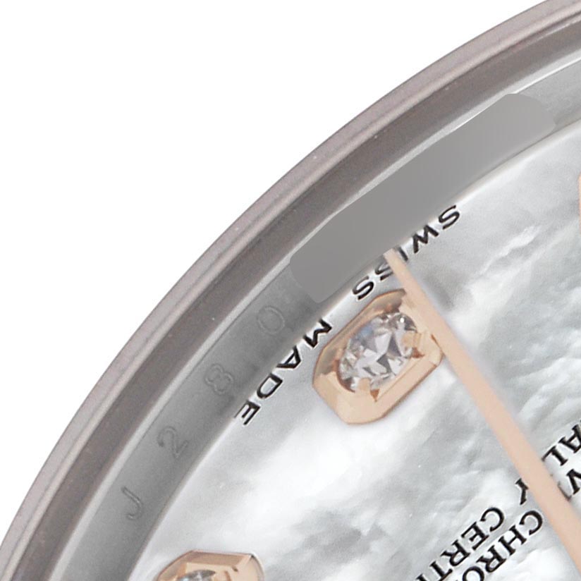 This close-up image shows a portion of the dial and diamond markers of a mid-size Rolex watch.