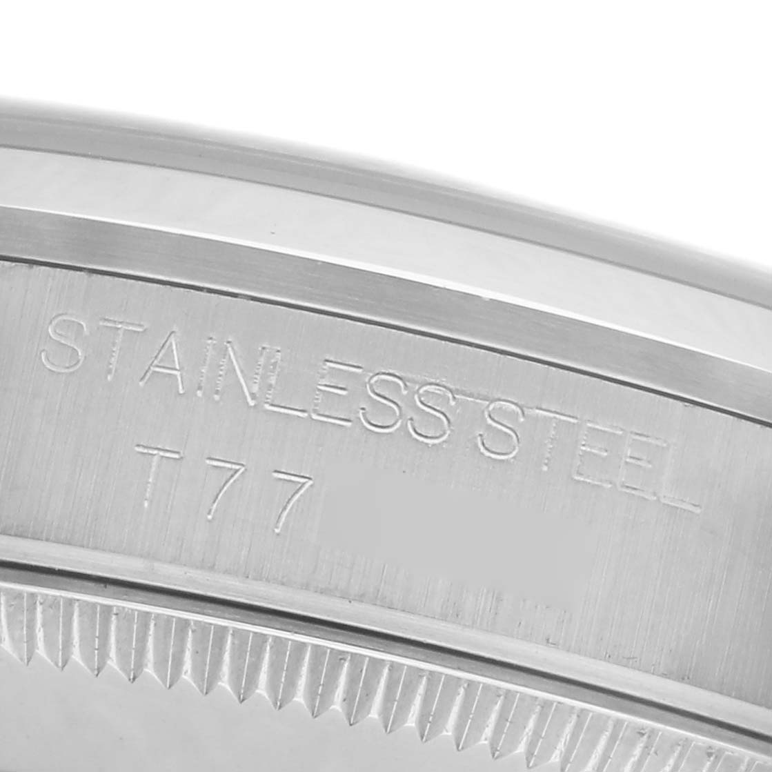 The image shows a close-up of the side of a Rolex Mid-Size 68240 Women's Stainless Steel Pink Dial 68240 Women's Stainless Steel Pink Dial watch, highlighting the engraved stainless steel markings.
