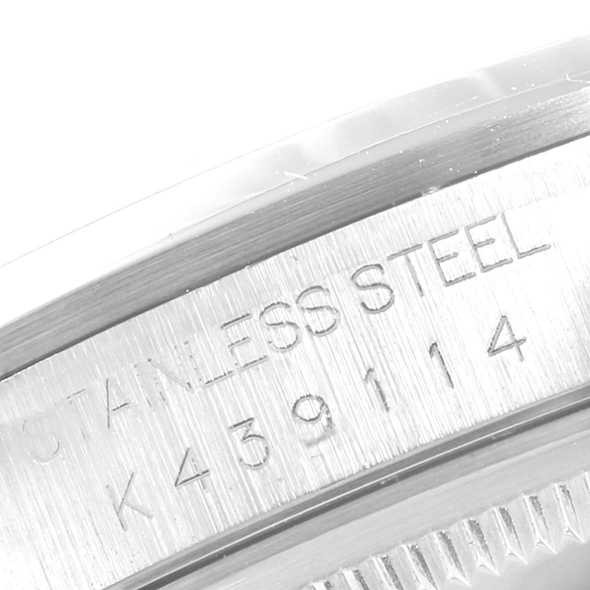 This image shows a close-up of the Rolex Datejust 16200 Men
s Stainless Steel Grey Dial 16200 Men
s Stainless Steel Grey Dial
s stainless steel case with an engraved serial number.