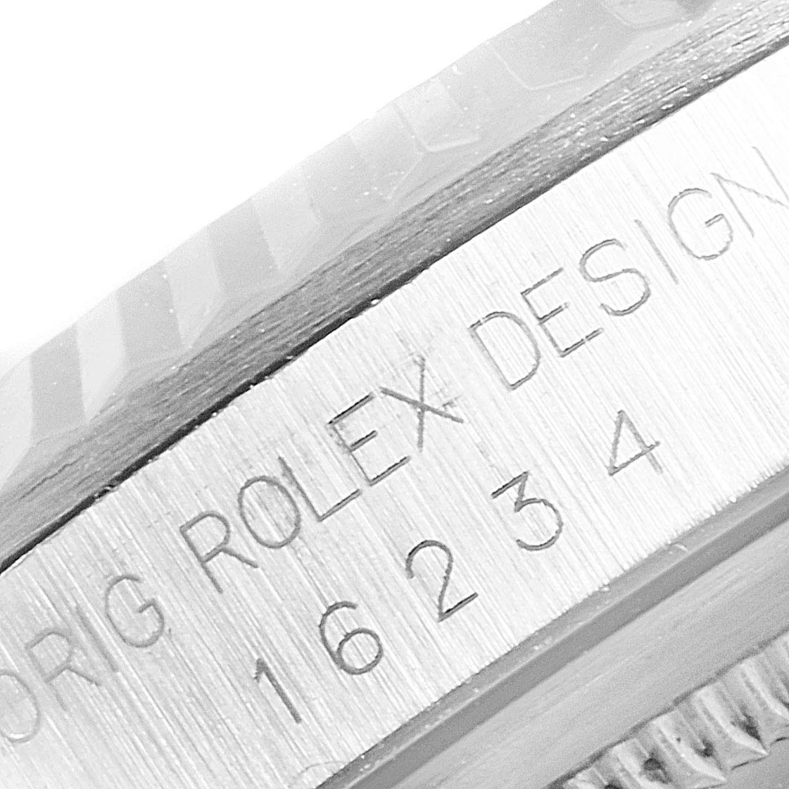 This close-up image shows the engraved serial number and "Rolex Design" marking on the side of a Rolex Datejust 16234 Men
s Stainless Steel Pink Dial 16234 Men
s Stainless Steel Pink Dial model.