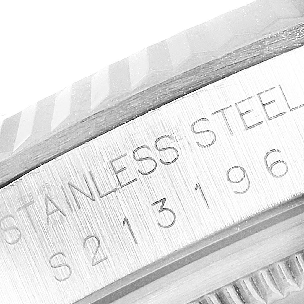 This image shows a close-up of the serial number and "STAINLESS STEEL" engraving on a Rolex Datejust 16234 Men
s Stainless Steel Pink Dial 16234 Men
s Stainless Steel Pink Dial model
s case.