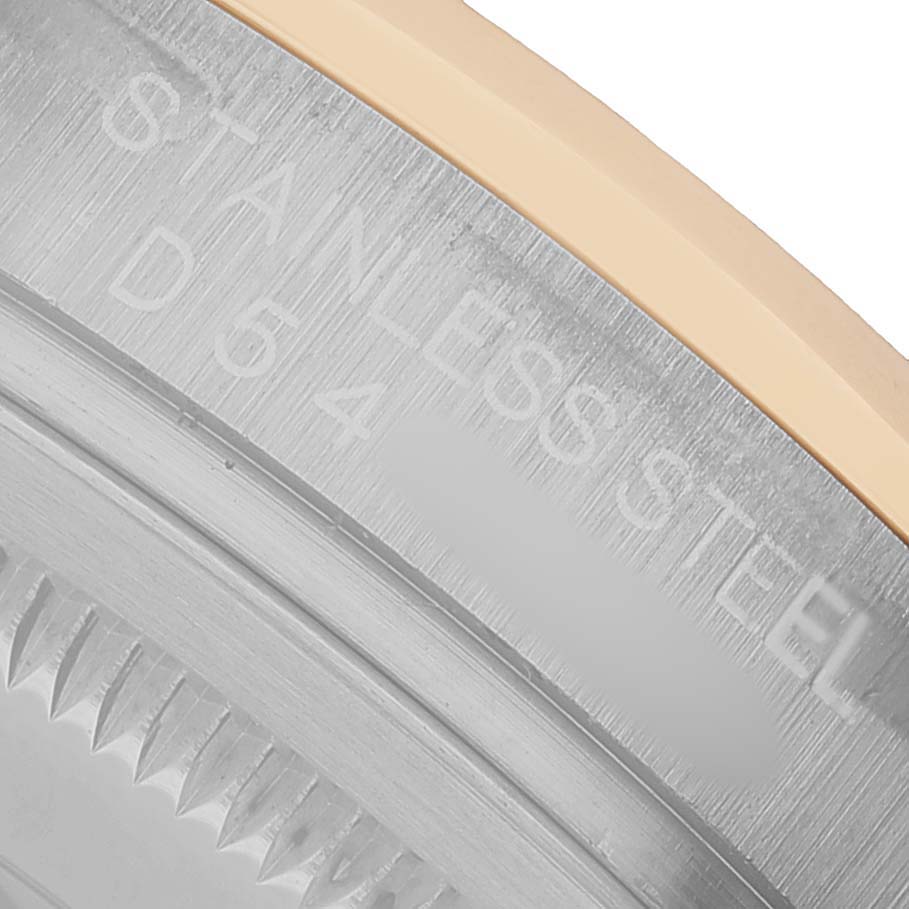 The image shows a close-up of the case back and bezel edge of a Rolex Datejust 116233 Men's Stainless Steel Champagne Dial, highlighting the stainless steel engraving.