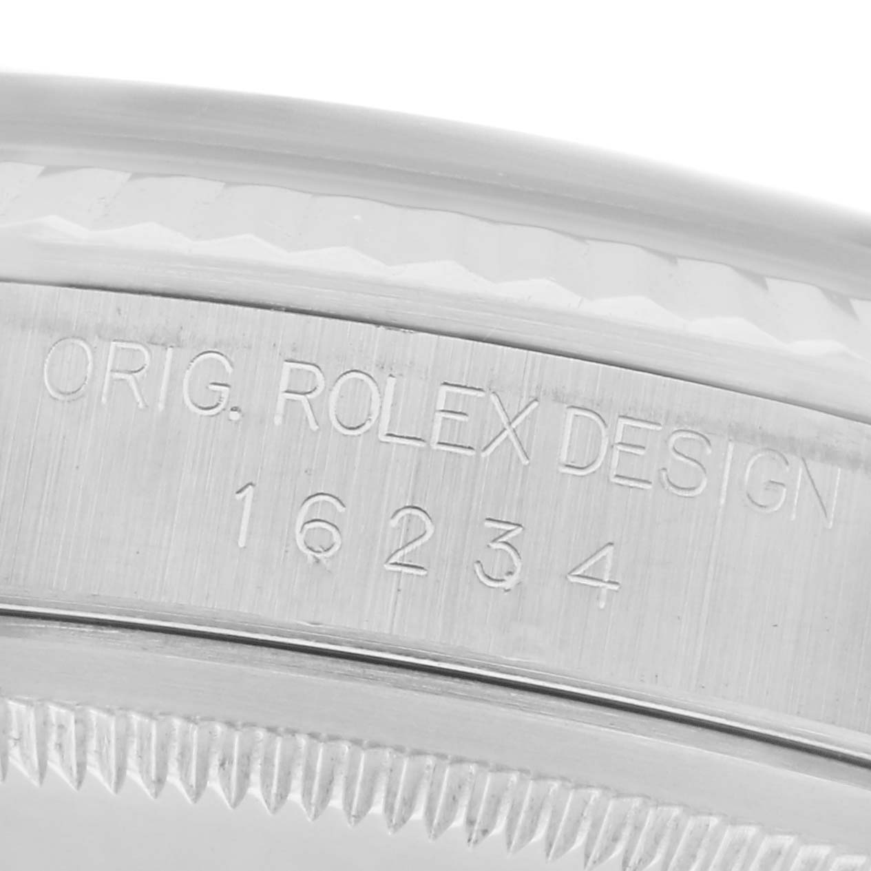 The image shows a close-up of the Rolex Datejust 16234 Men's Stainless Steel White Dial 16234 Men's Stainless Steel White Dial model's case, displaying the serial number and "ORIG. ROLEX DESIGN" engraving.