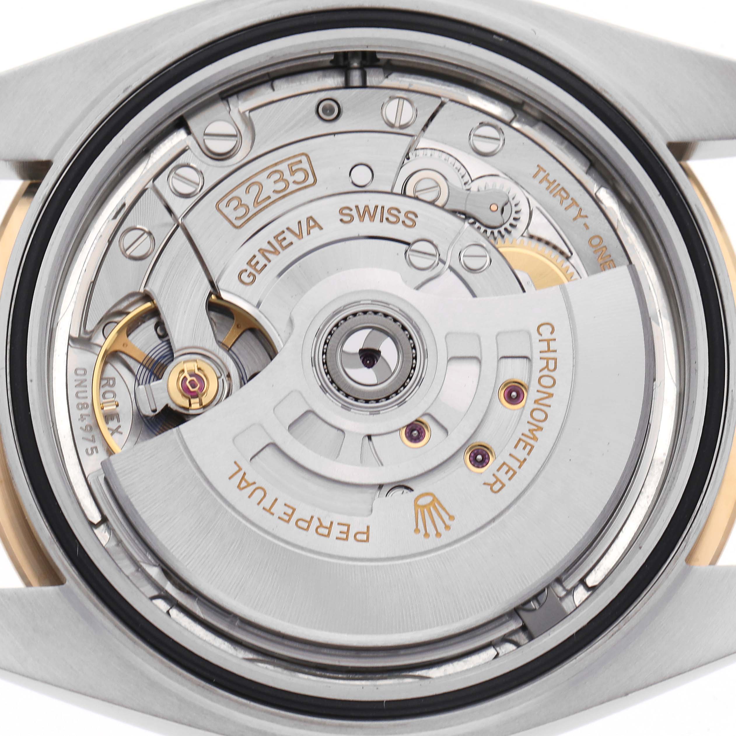 The image shows the movement of a Rolex Datejust 41 126333 Men
s Steel and Gold (two tone) Silver Dial 126333 Men
s Steel and Gold (two tone) Silver Dial, focusing on the rotor and intricate components from a back angle.