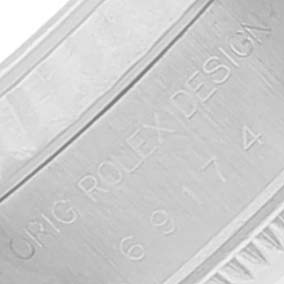 This is a close-up of the inner side of the band or case of a Rolex Datejust 69174 Women
s Stainless Steel Blue Dial 69174 Women
s Stainless Steel Blue Dial watch, showing its engraving.