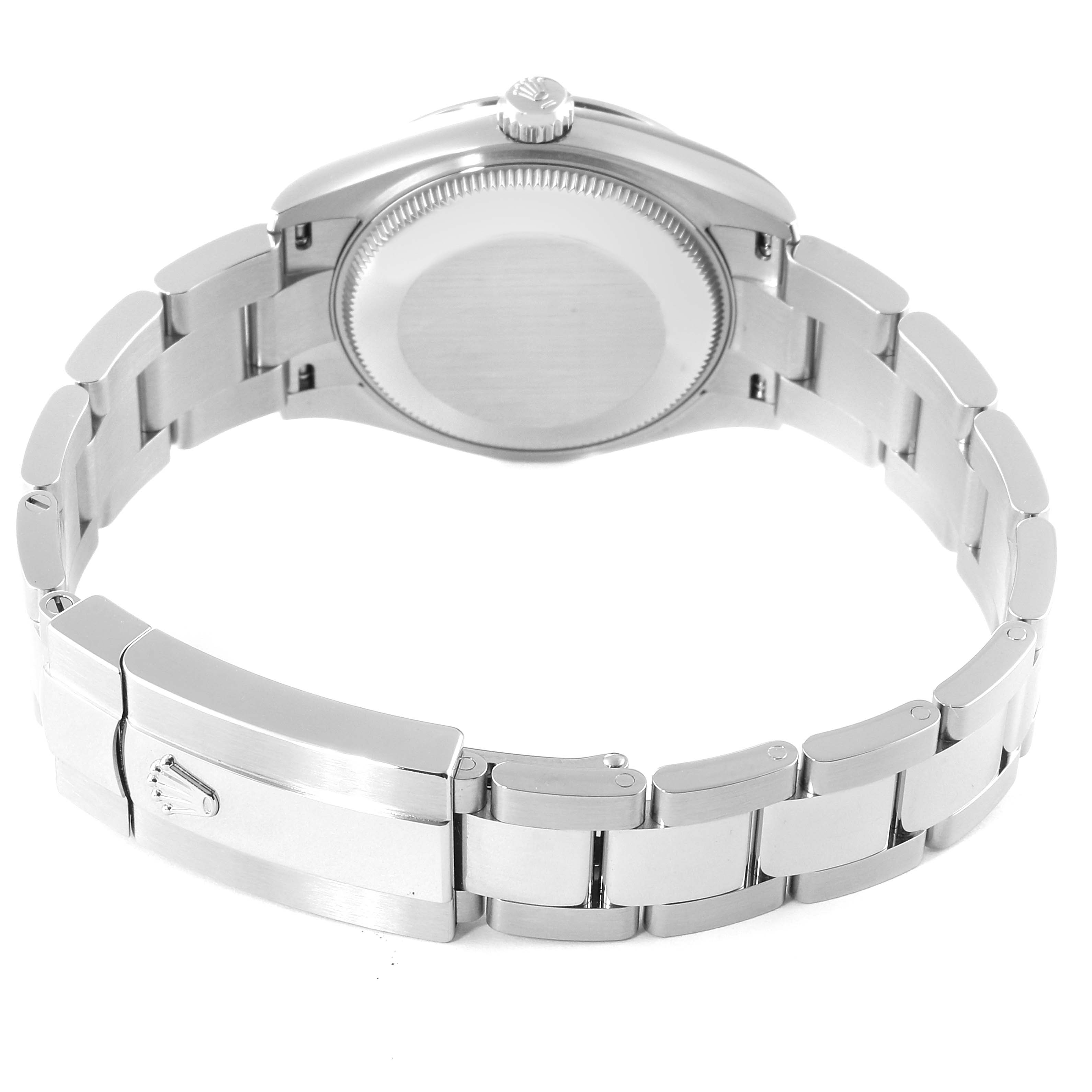 The image shows the back of a mid-size Rolex watch, focusing on its closed clasp, bracelet, and caseback.