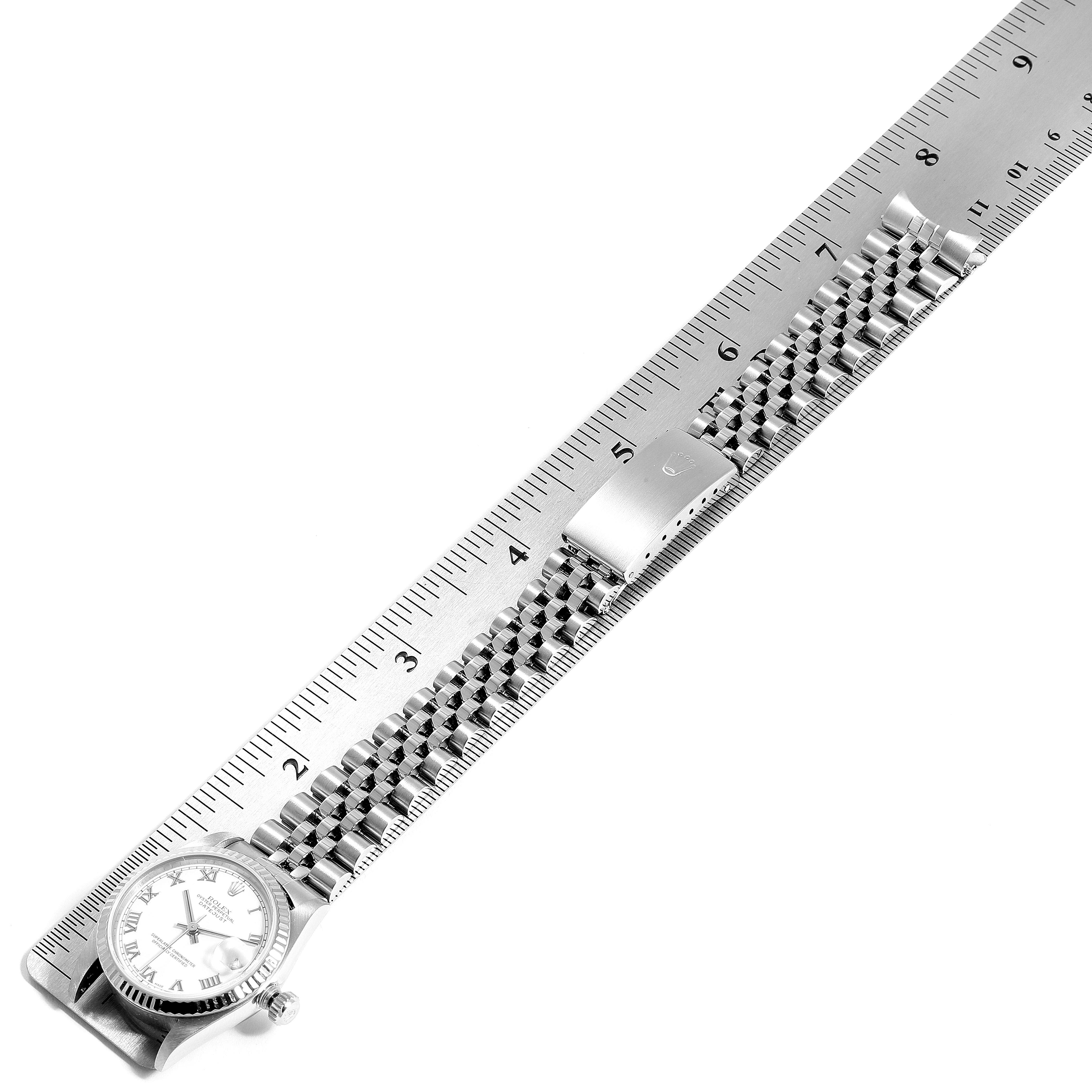 The Rolex Mid-Size 78274 Women
s Stainless Steel White Dial 78274 Women
s Stainless Steel White Dial watch is shown flat, displaying the face, strap, and clasp against a ruler for measurement.