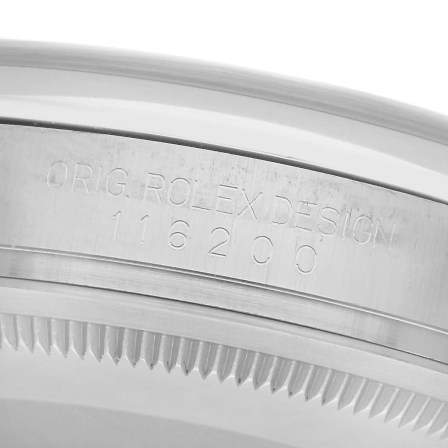 The image shows the side view of a Rolex Datejust 116200 Men's Stainless Steel Silver Dial 116200 Men's Stainless Steel Silver Dial, focusing on the engraved case and bezel.