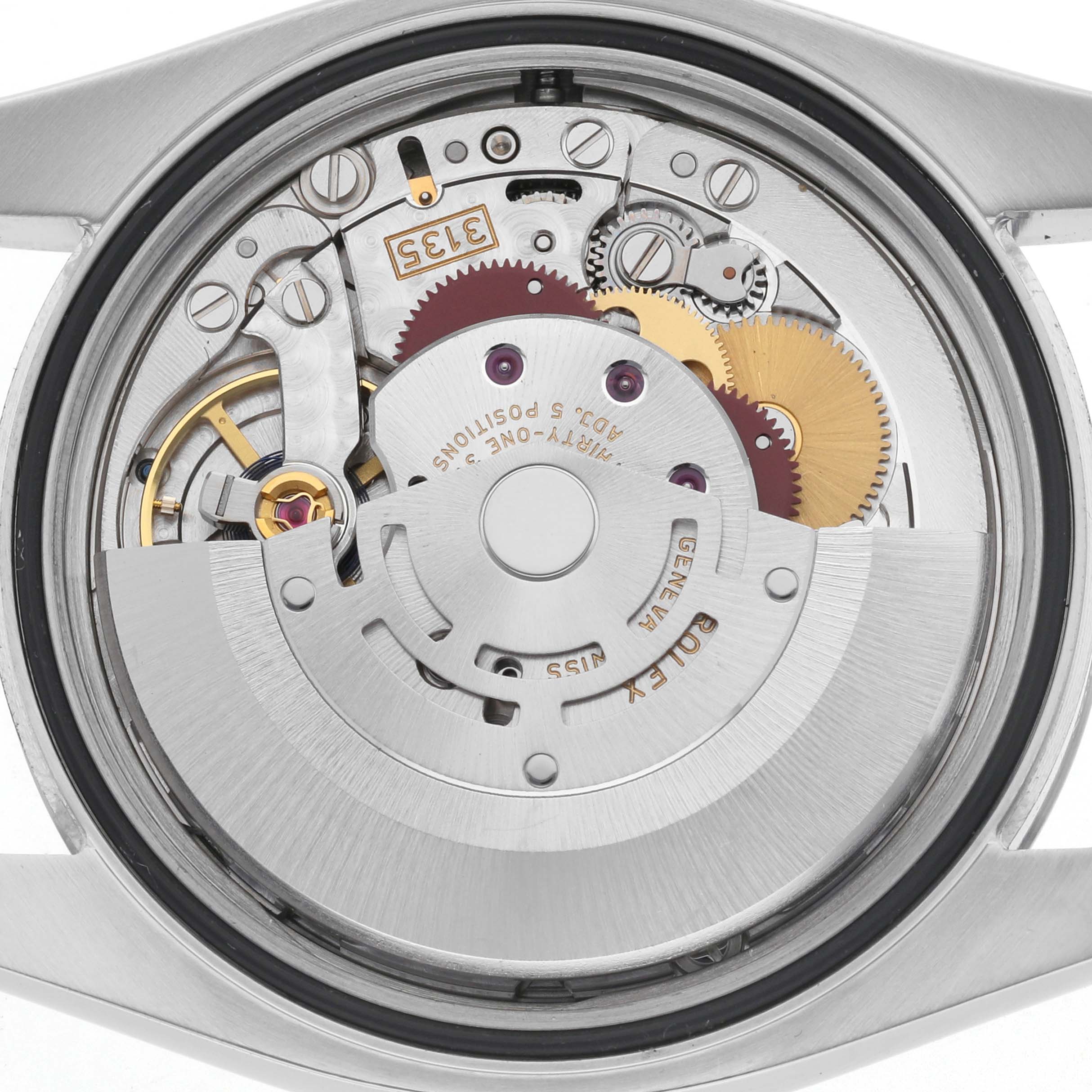 The image shows the Rolex Datejust 116200 Men's Stainless Steel Silver Dial 116200 Men's Stainless Steel Silver Dial watch's movement from a back angle, highlighting its gears and mechanical components.