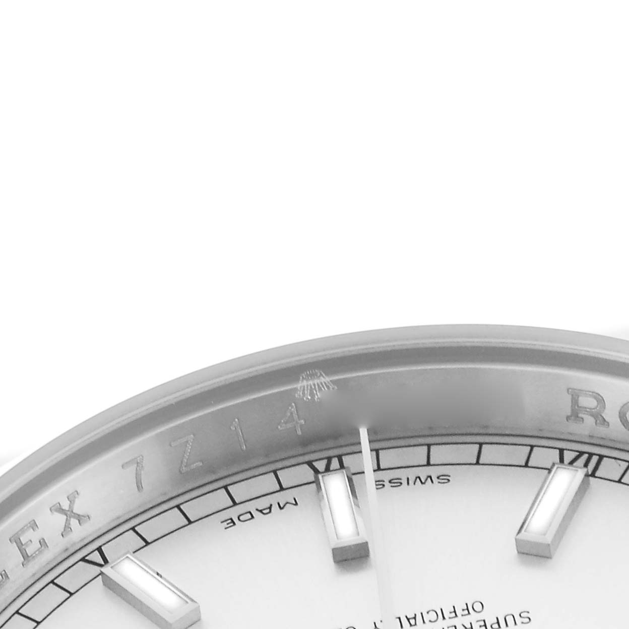 The image shows a close-up of the Rolex Datejust 116200 Men's Stainless Steel Silver Dial 116200 Men's Stainless Steel Silver Dial's dial, focusing on the hour markers and part of the bezel.