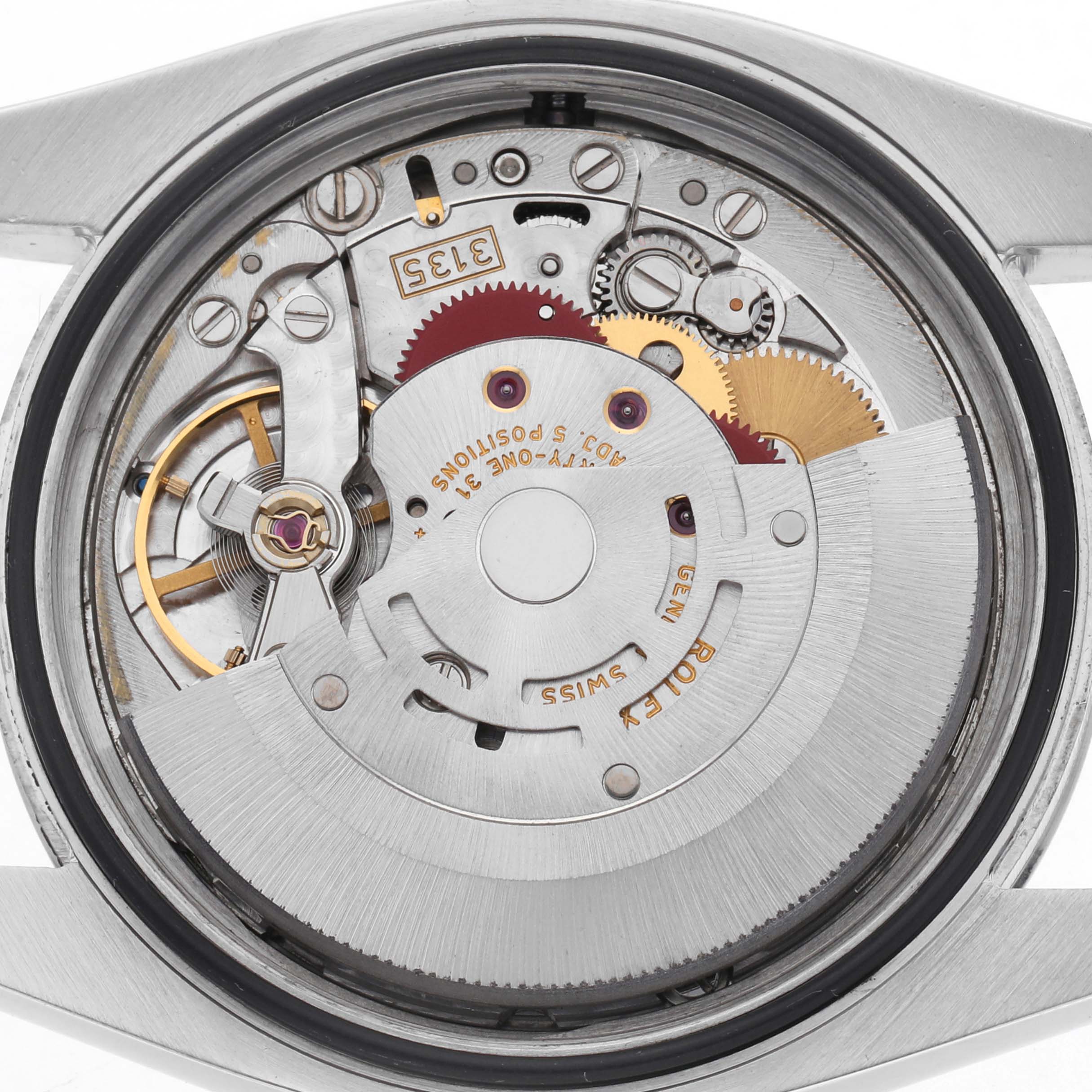 The image shows the back view of a Rolex Datejust 116200 Men's Stainless Steel Silver Dial 116200 Men's Stainless Steel Silver Dial, focusing on its movement and mechanical components.