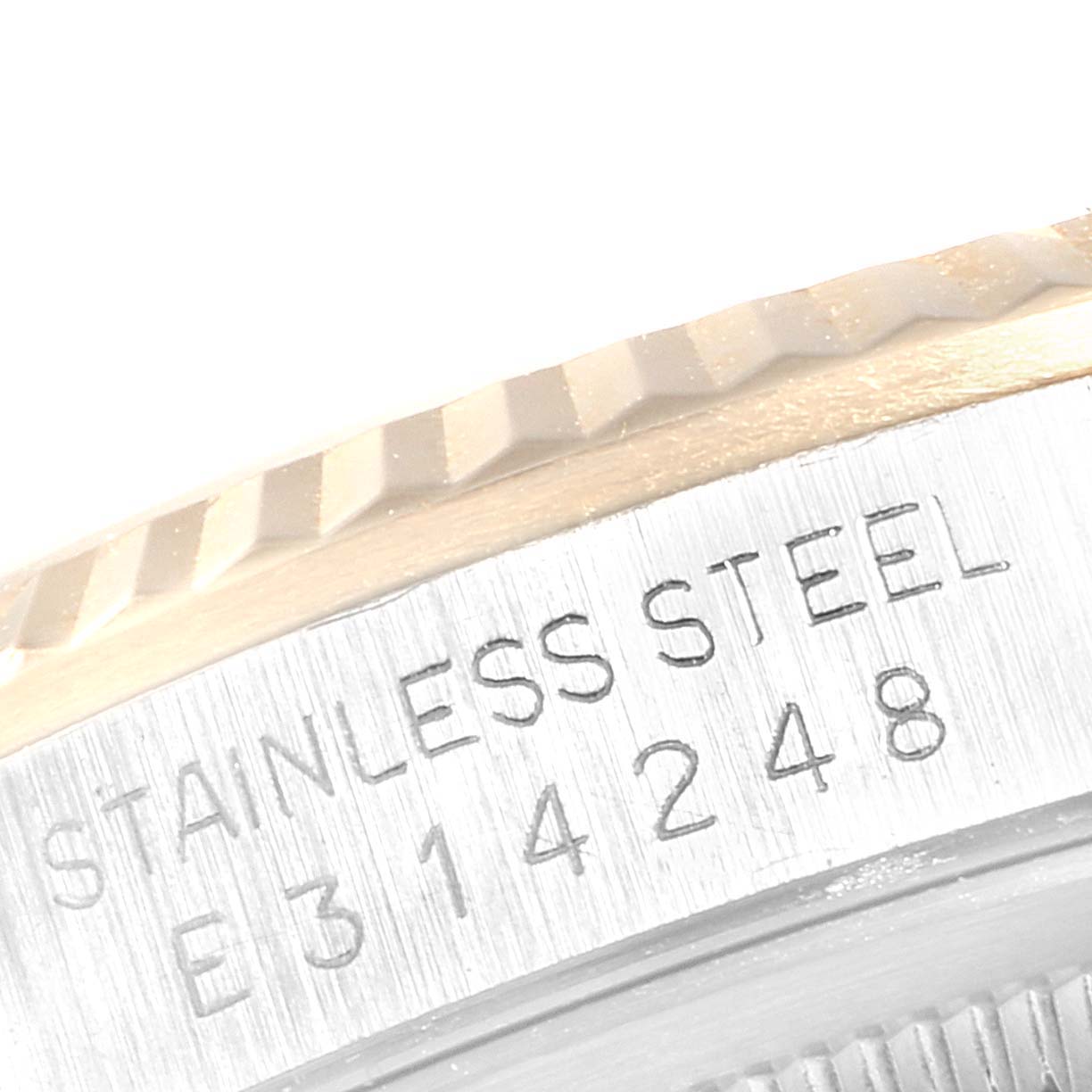 The image shows a close-up of the casing, serial number, and part of the bezel of the Rolex Datejust 16233 Men
s Steel and Gold (two tone) Champagne Dial 16233 Men
s Steel and Gold (two tone) Champagne Dial watch.