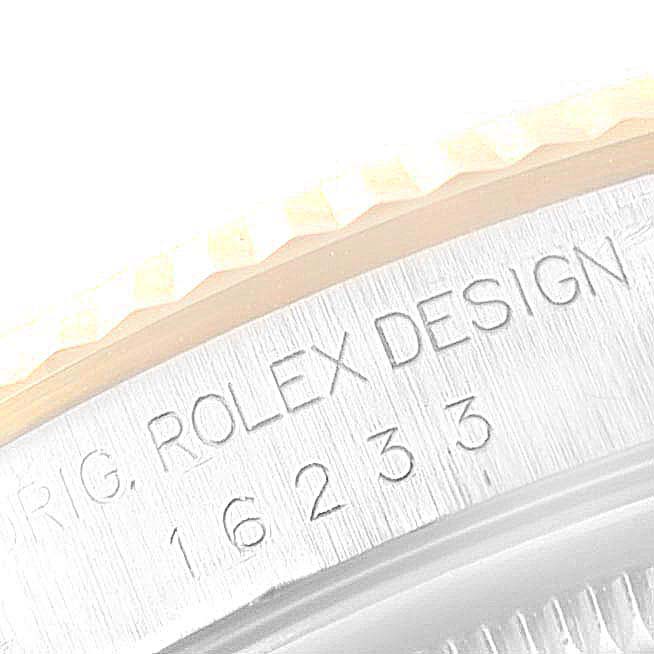 This image shows a close-up of the bezel and case side of a Rolex Datejust 16233 Men
s Steel and Gold (two tone) Champagne Dial 16233 Men
s Steel and Gold (two tone) Champagne Dial watch, revealing the engraved model number and "Rolex Design" text.