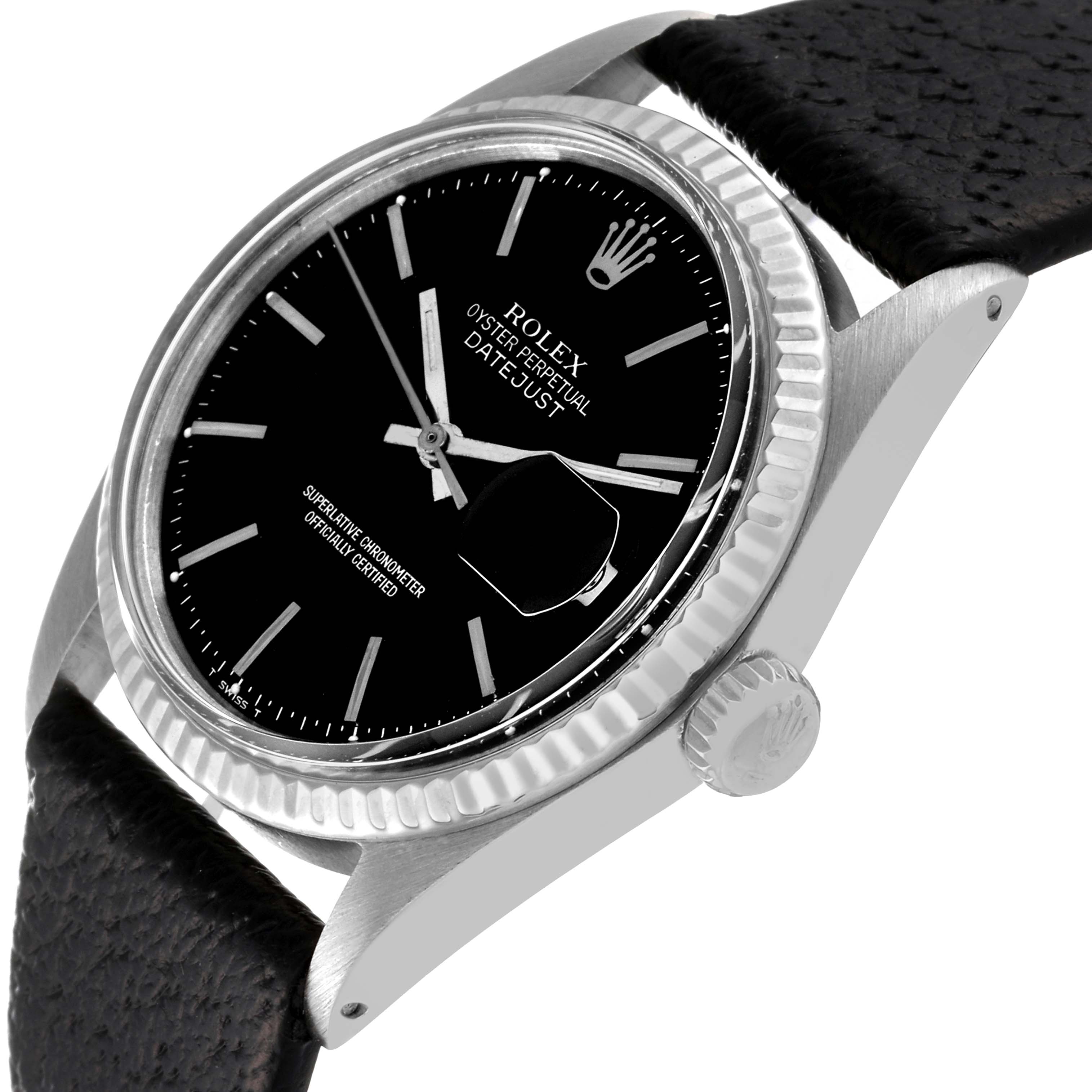 The image shows a Rolex Vintage Collection 1601 Men's Stainless Steel Black Dial 1601 Men's Stainless Steel Black Dial model Datejust watch at a slanted angle, highlighting its black dial, crown, case, and leather strap.