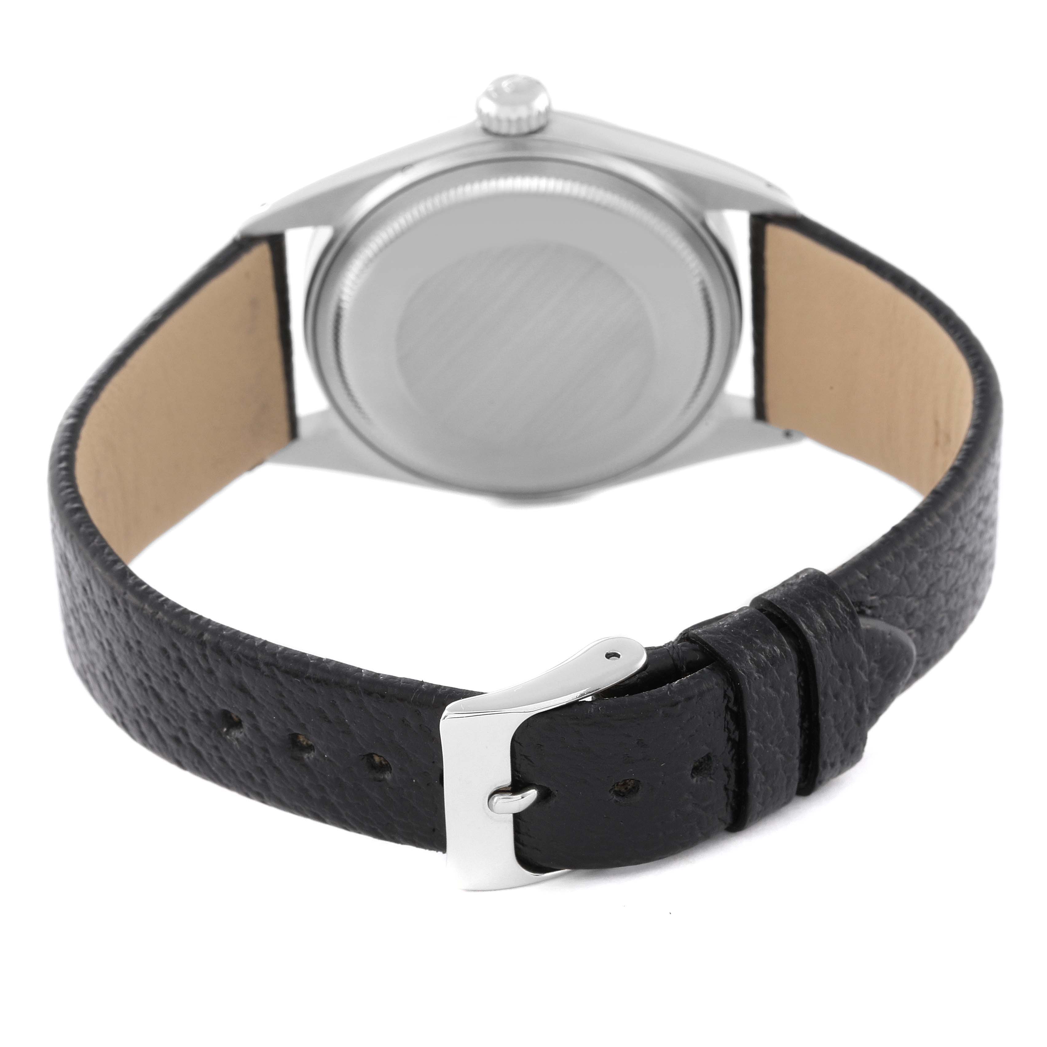 The image shows the back view of a Vintage Collection Rolex watch, highlighting the case back and black leather strap with buckle.