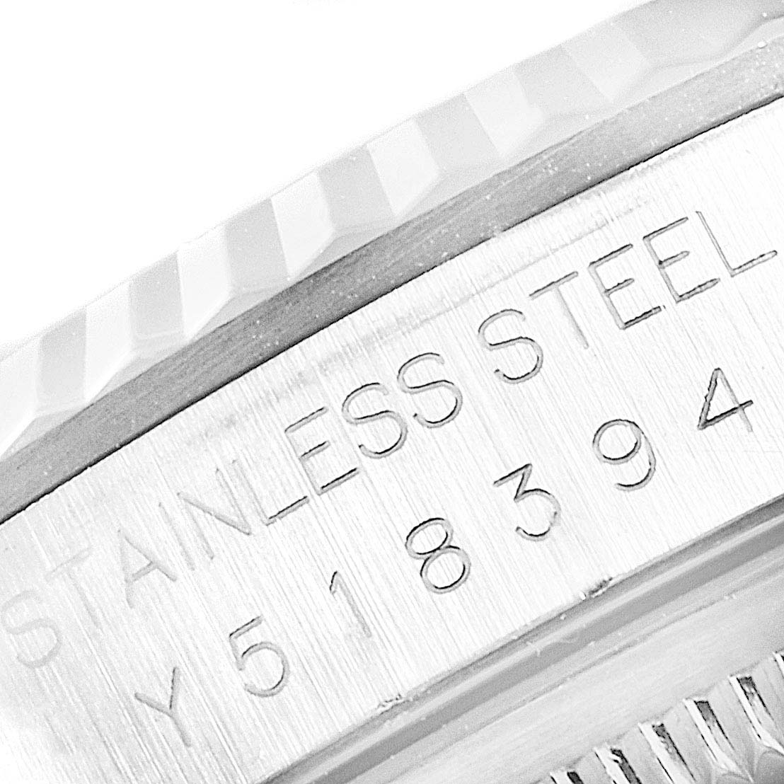 The image shows a close-up of the bezel and case side of a Rolex Datejust 16234 Men
s Stainless Steel Black Dial 16234 Men
s Stainless Steel Black Dial watch with the engraved serial number and "STAINLESS STEEL" inscription.