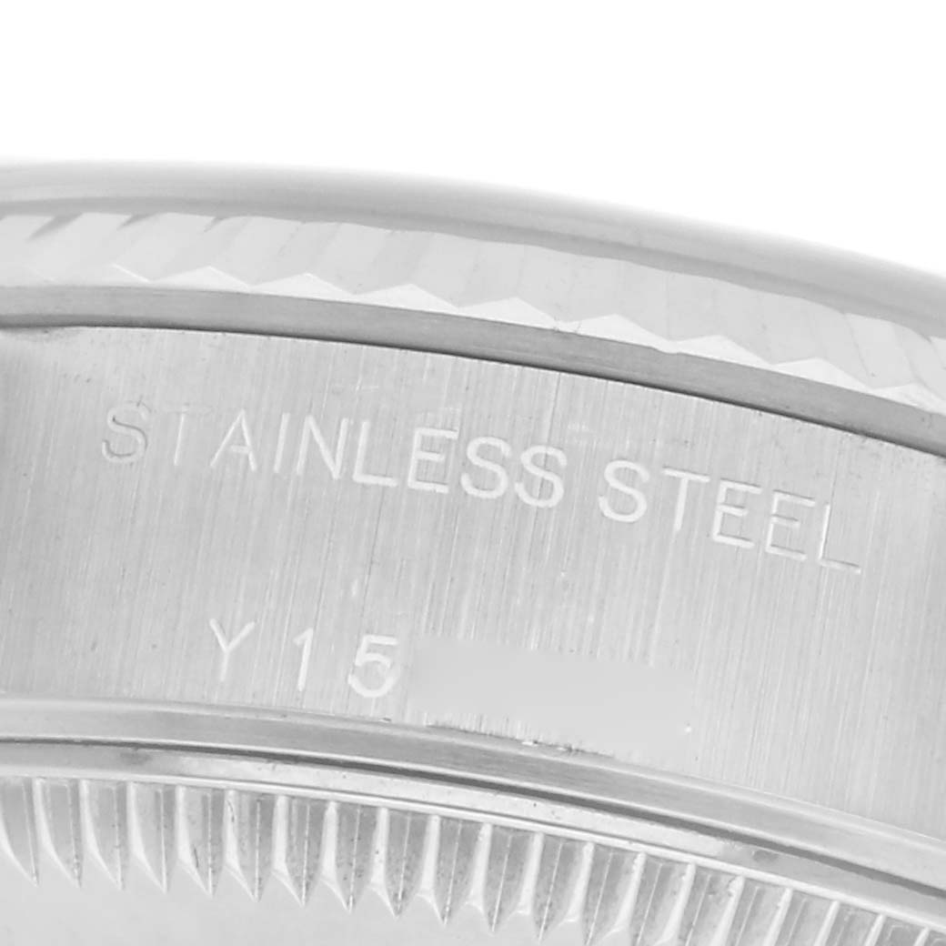 The image shows a close-up of the side of a Rolex Datejust 79174 Women
s Stainless Steel Blue Dial 79174 Women
s Stainless Steel Blue Dial watch
s stainless steel case with engravings.