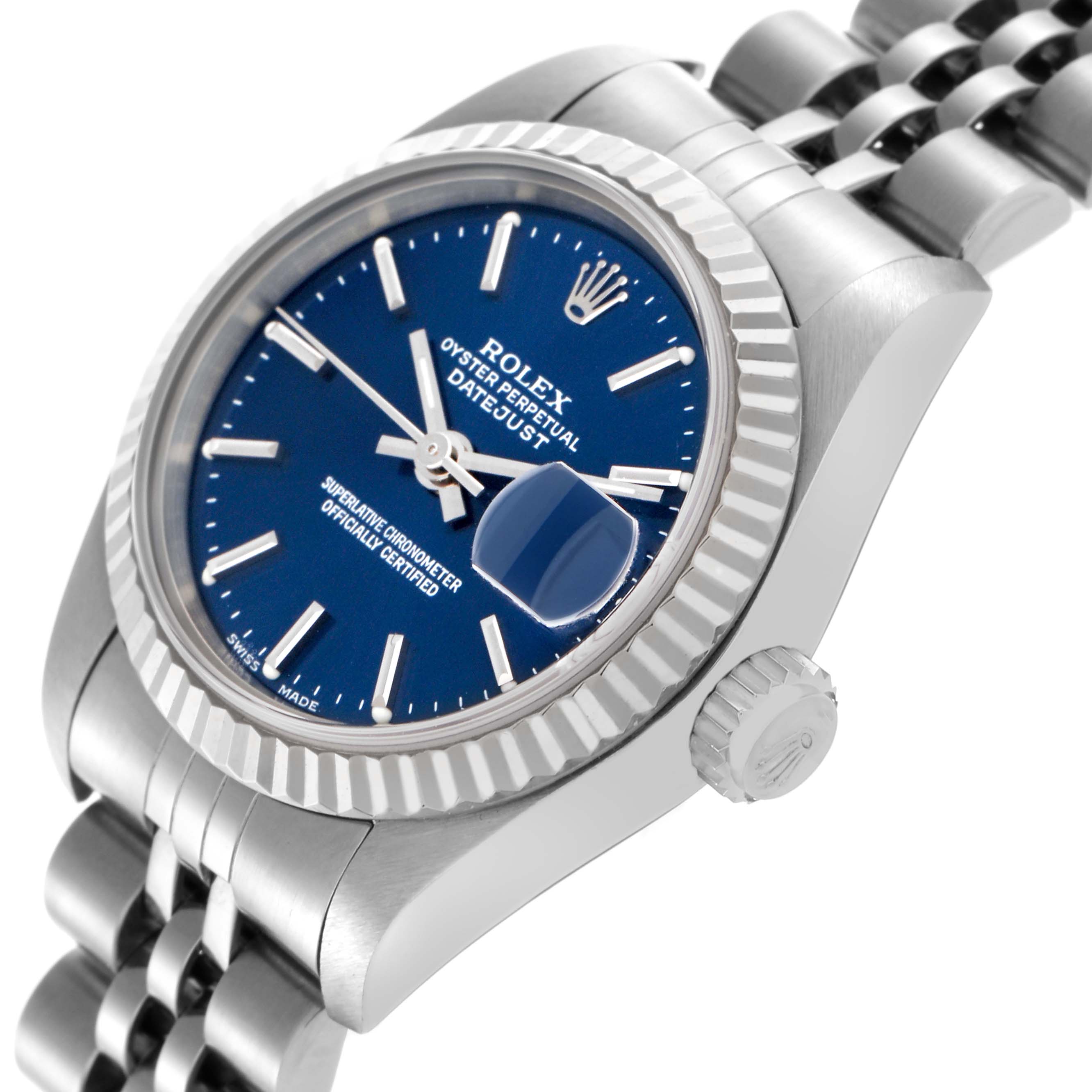 The image shows a Rolex Datejust 79174 Women
s Stainless Steel Blue Dial 79174 Women
s Stainless Steel Blue Dial watch at an angled side view, highlighting the blue dial, crown, and Jubilee bracelet.