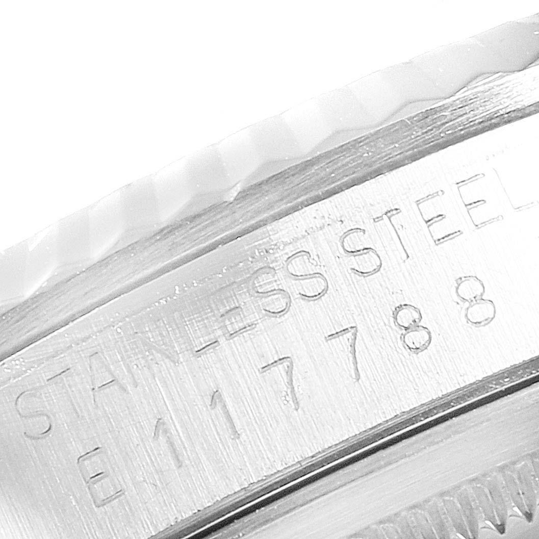 This image shows a close-up of the "STAINLESS STEEL" engraving and serial number on the bezel of a Rolex Datejust 16234 Men's Stainless Steel Silver Dial 16234 Men's Stainless Steel Silver Dial watch.