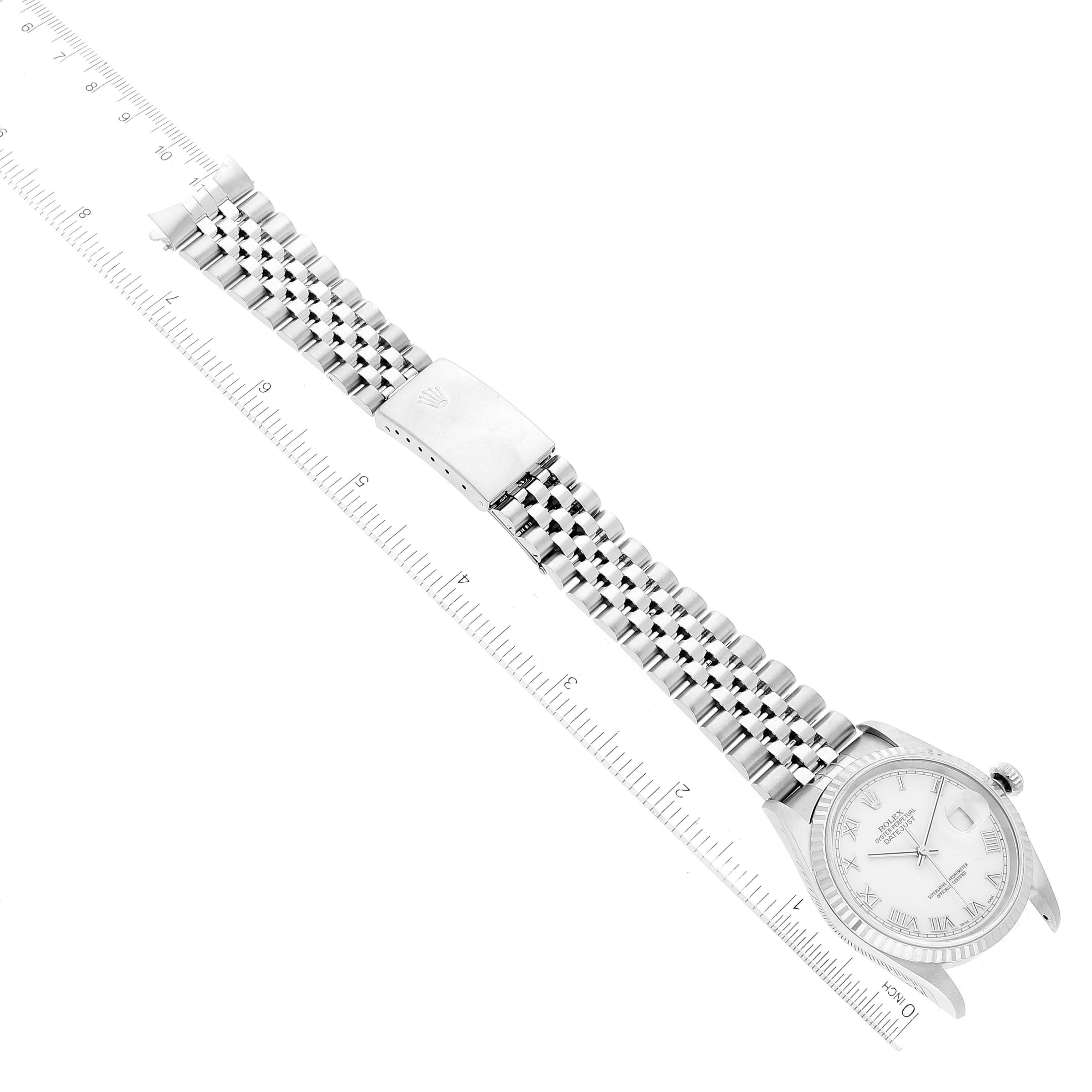 The image shows a top-down view of a Rolex Datejust 16234 Men's Stainless Steel White Dial 16234 Men's Stainless Steel White Dial watch and its full metal bracelet alongside a measuring ruler.