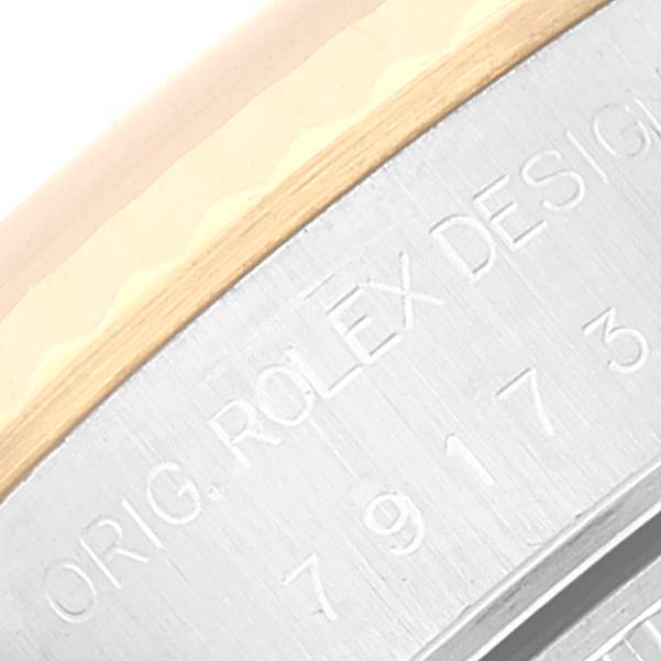This close-up image shows the engraved model number and part of the bezel of a Rolex Datejust 79173 Women's Steel and Gold (two tone) Champagne Dial 79173 Women's Steel and Gold (two tone) Champagne Dial watch.