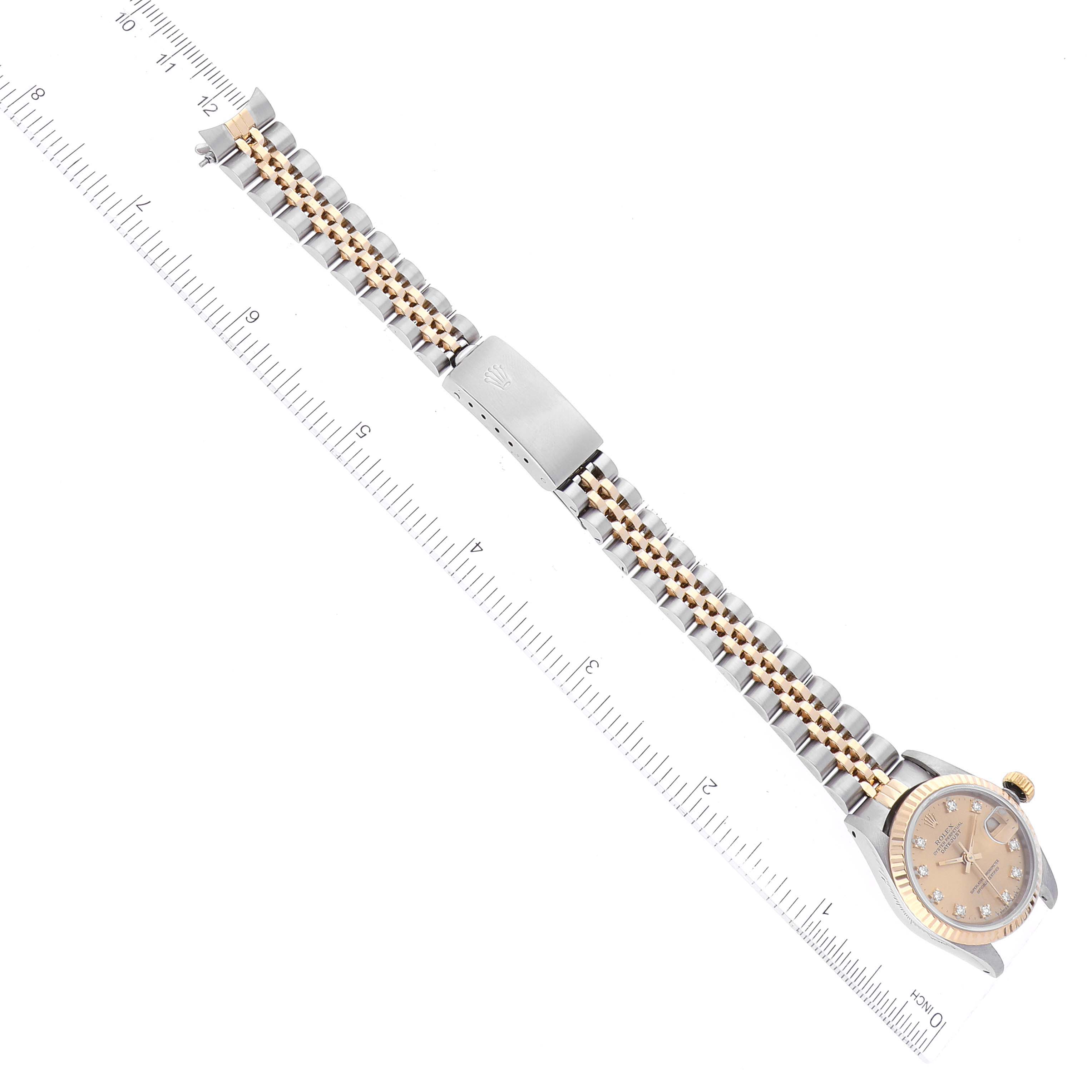 The image shows a Rolex Datejust 69173 Women's Steel and Gold (two tone) Champagne Dial 69173 Women's Steel and Gold (two tone) Champagne Dial watch from a top-down angle, highlighting the face, bracelet, and clasp, alongside a ruler.