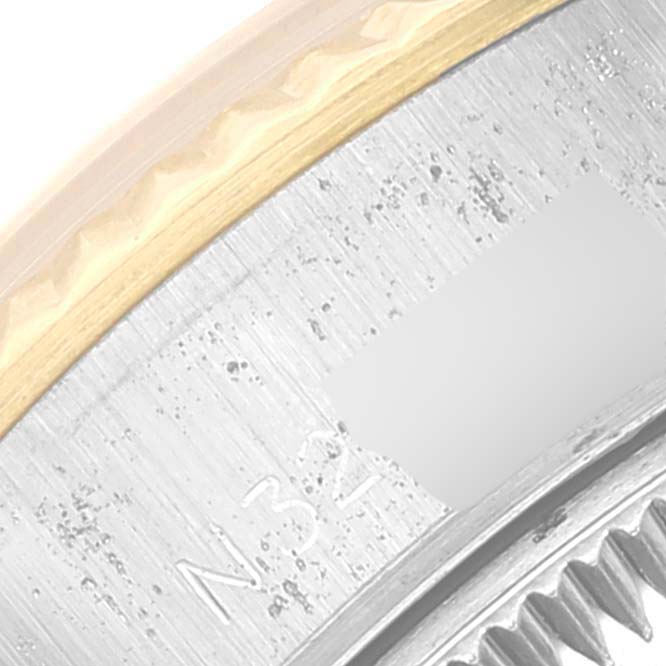 This image shows a close-up of the bezel and part of the crown of a Rolex Datejust 69173 Women's Steel and Gold (two tone) Champagne Dial 69173 Women's Steel and Gold (two tone) Champagne Dial watch.