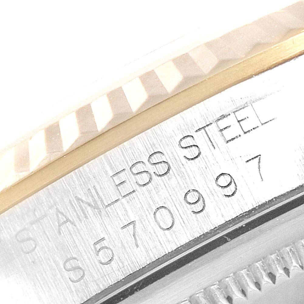 This image shows a close-up of the serial number and fluted bezel of a Rolex Datejust 16233 Men
s Steel and Gold (two tone) Champagne Dial 16233 Men
s Steel and Gold (two tone) Champagne Dial watch.