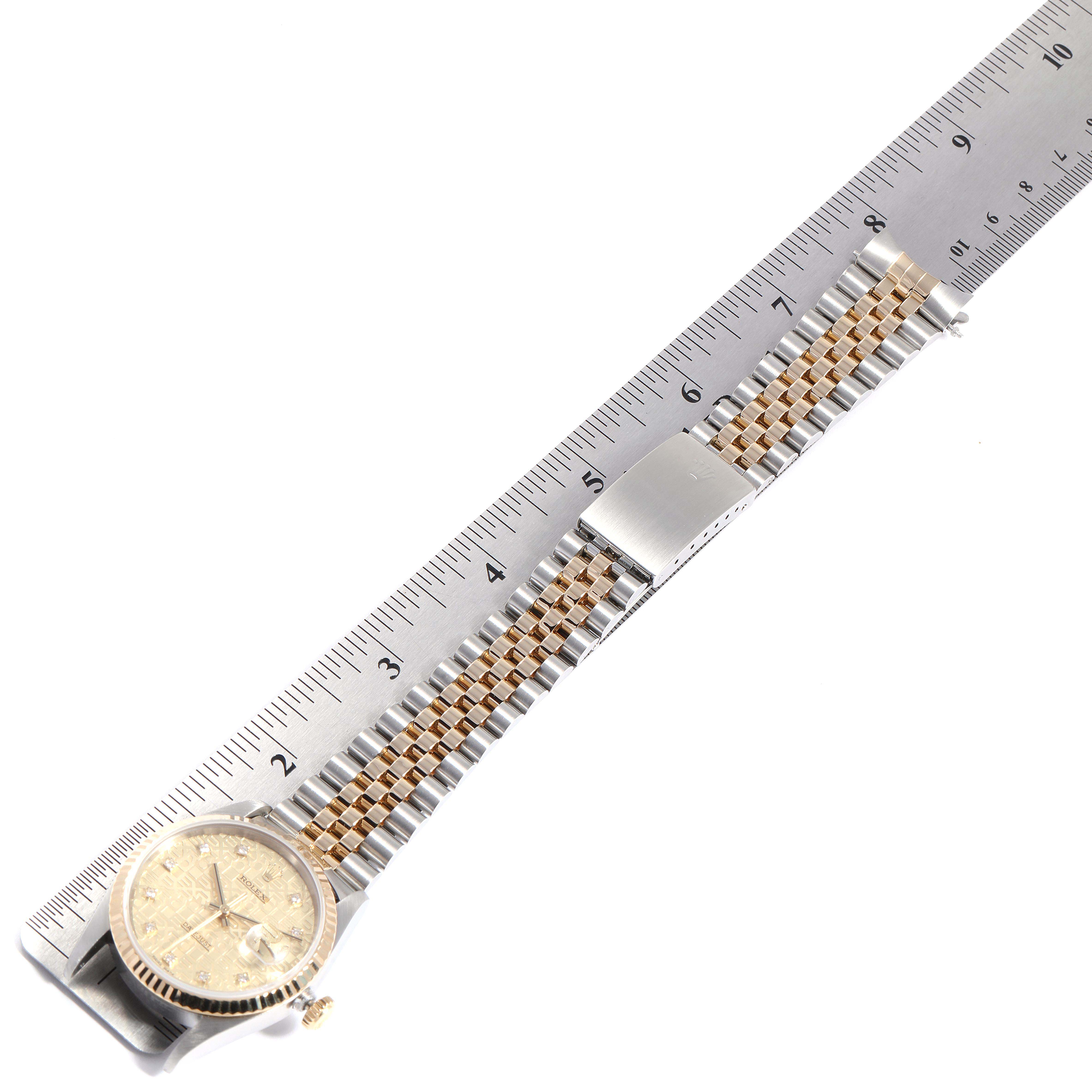The image shows a Rolex Datejust 16233 Men
s Steel and Gold (two tone) Champagne Dial 16233 Men
s Steel and Gold (two tone) Champagne Dial watch laid flat along a ruler, displaying its dial, bracelet, and clasp.