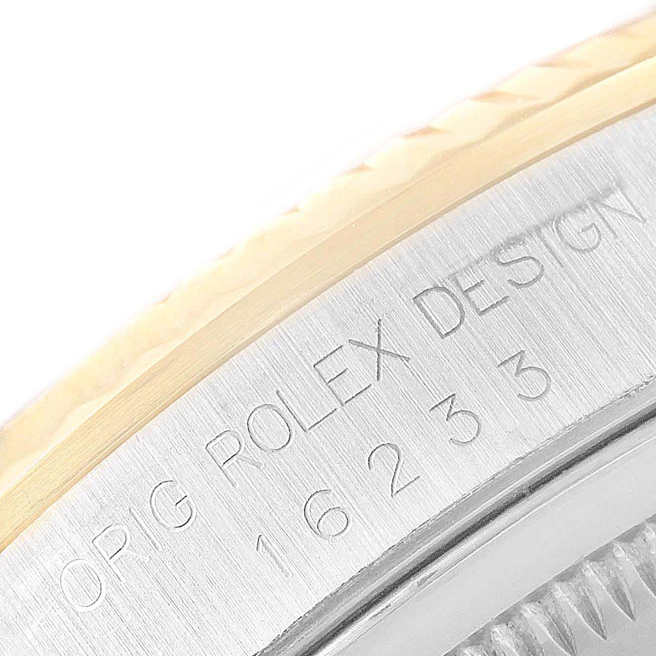 The image shows a close-up of the side of a Rolex Datejust 16233 Men
s Steel and Gold (two tone) Champagne Dial 16233 Men
s Steel and Gold (two tone) Champagne Dial watch, highlighting the bezel and engraved model number.