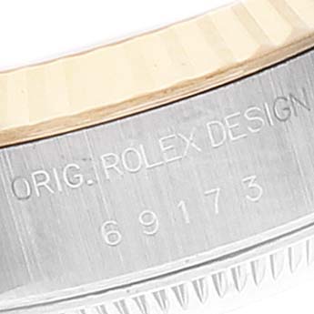 Close-up of the side engraving on a Rolex Datejust 69173 Women
s Steel and Gold (two tone) Champagne Dial 69173 Women
s Steel and Gold (two tone) Champagne Dial model, showing "ORIG. ROLEX DESIGN" and model number 69173.