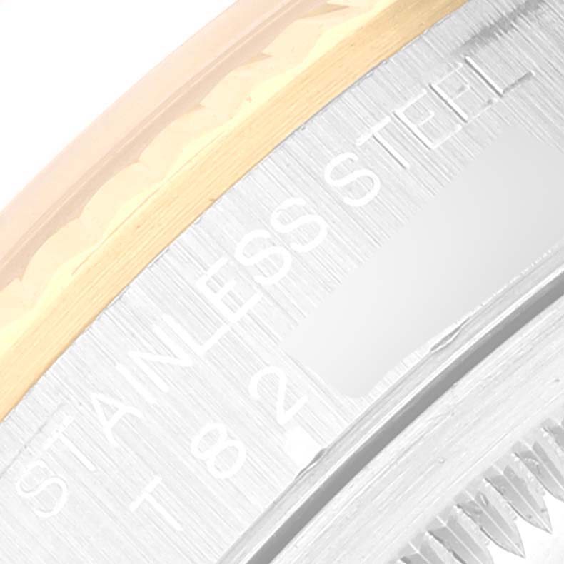 This image shows a close-up of the case back and edge of the bezel of a Rolex Datejust 16233 Men's Steel and Gold (two tone) Mother of Pearl Dial 16233 Men's Steel and Gold (two tone) Mother of Pearl Dial watch, highlighting the "STAINLESS STEEL" engraving.