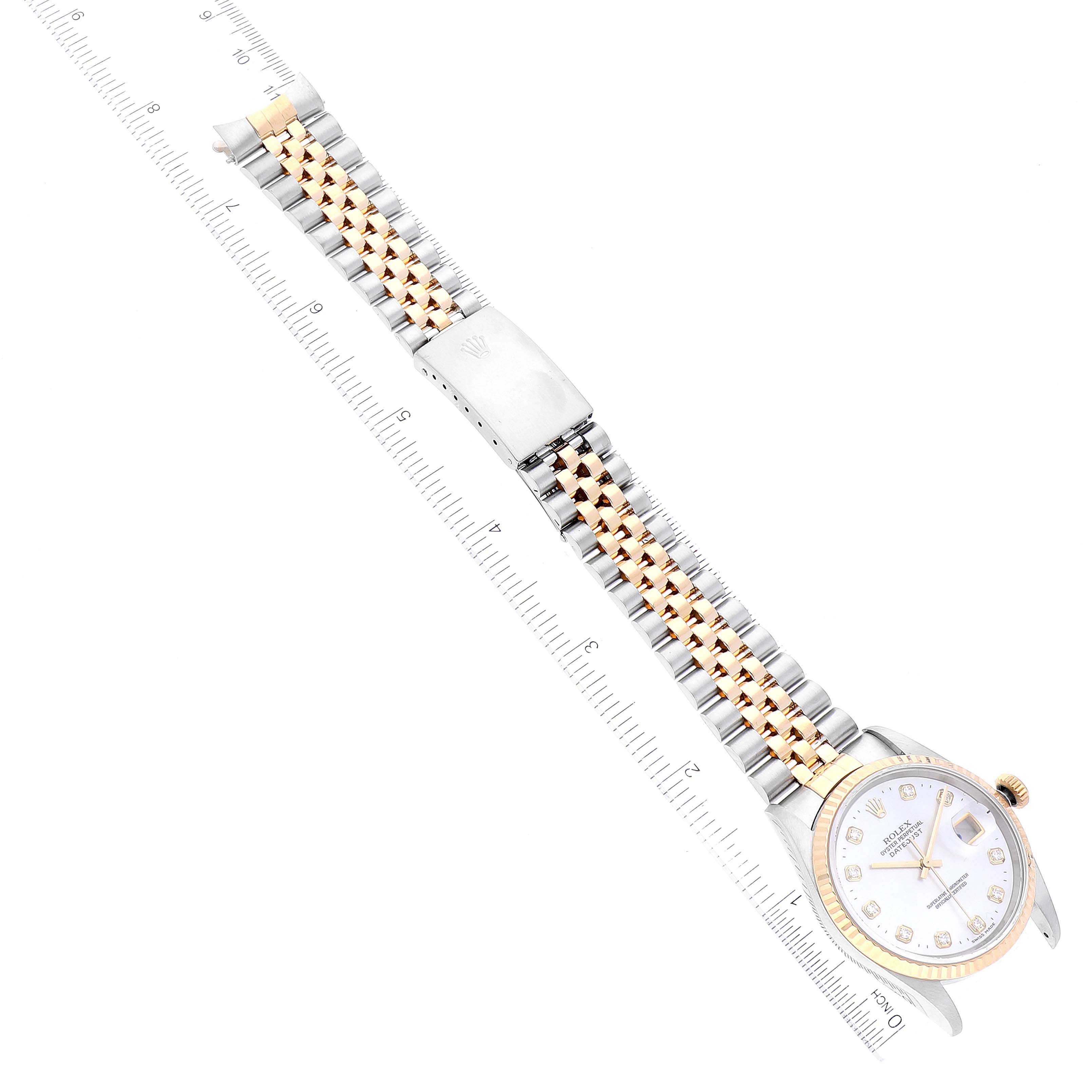 The image shows a Rolex Datejust 16233 Men's Steel and Gold (two tone) Mother of Pearl Dial 16233 Men's Steel and Gold (two tone) Mother of Pearl Dial watch laid flat with a two-tone bracelet and a measuring ruler beside it.