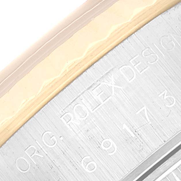 This image shows a close-up view of the model and serial number engraving on the side of a Rolex Datejust 69173 Women's Steel and Gold (two tone) Grey Dial 69173 Women's Steel and Gold (two tone) Grey Dial watch case.