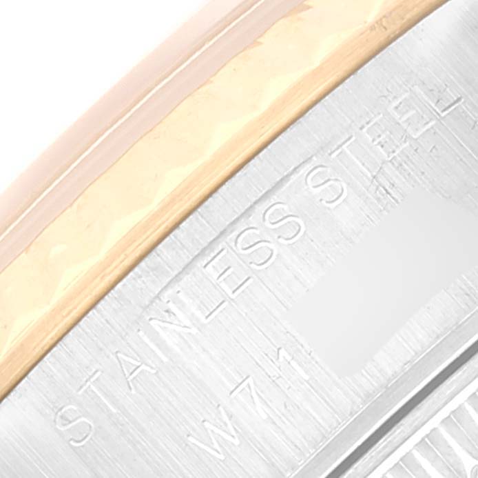 This image shows a close-up of the side of a Rolex Datejust 69173 Women's Steel and Gold (two tone) Grey Dial 69173 Women's Steel and Gold (two tone) Grey Dial watch, highlighting the bezel and the "STAINLESS STEEL" engraving.