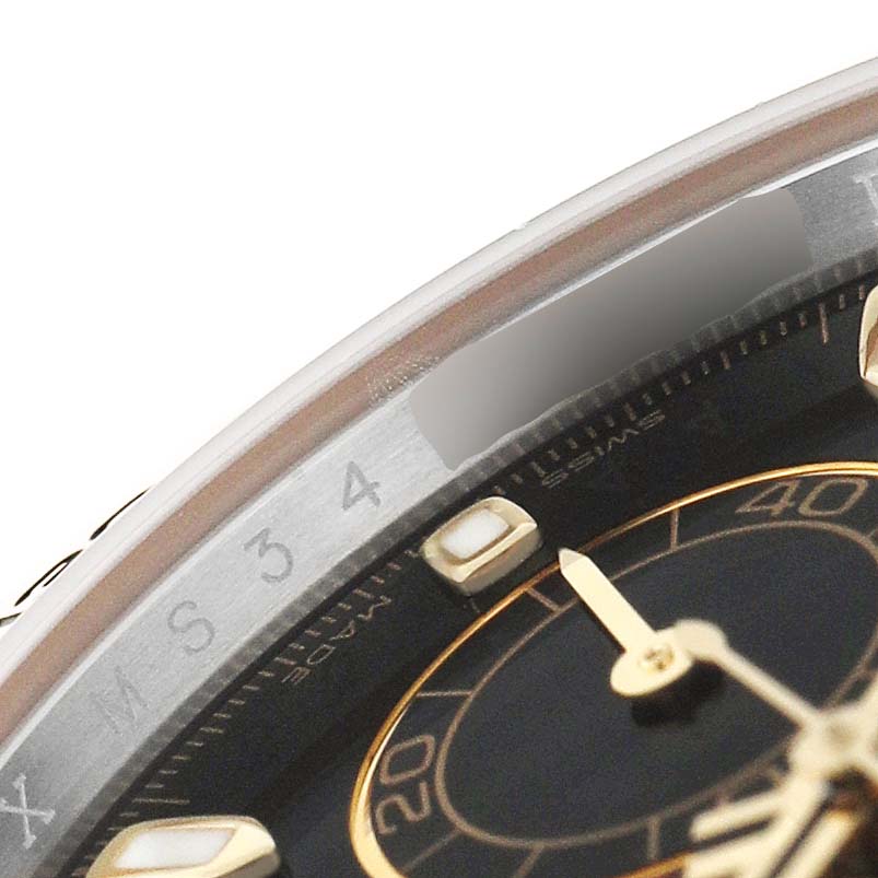 The image shows a close-up of the dial and bezel of a Rolex Daytona 116503 Men's Stainless Steel Black Dial watch at an oblique angle, highlighting the indices and hands.