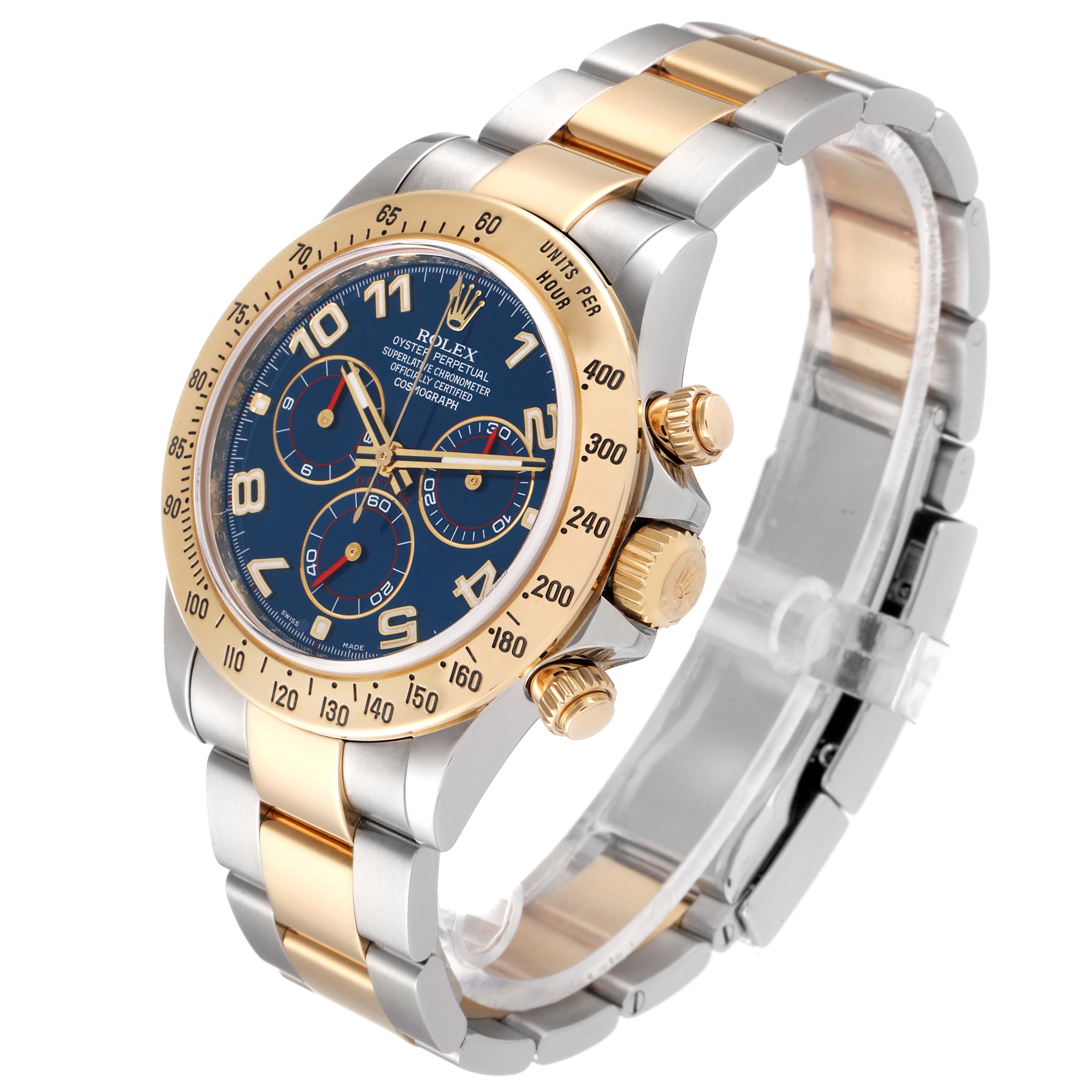 The Rolex Daytona 116523 Men's Steel and Gold (two tone) Blue Dial 116523 Men's Steel and Gold (two tone) Blue Dial watch is shown at a three-quarter angle, highlighting its blue dial, gold bezel, and two-tone bracelet.