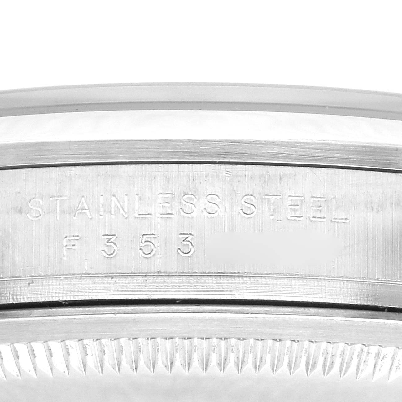 The image shows a close-up of the side view of a Rolex Explorer 114270 Men's Stainless Steel Black Dial 114270 Men's Stainless Steel Black Dial watch, focusing on the engraved stainless steel area.