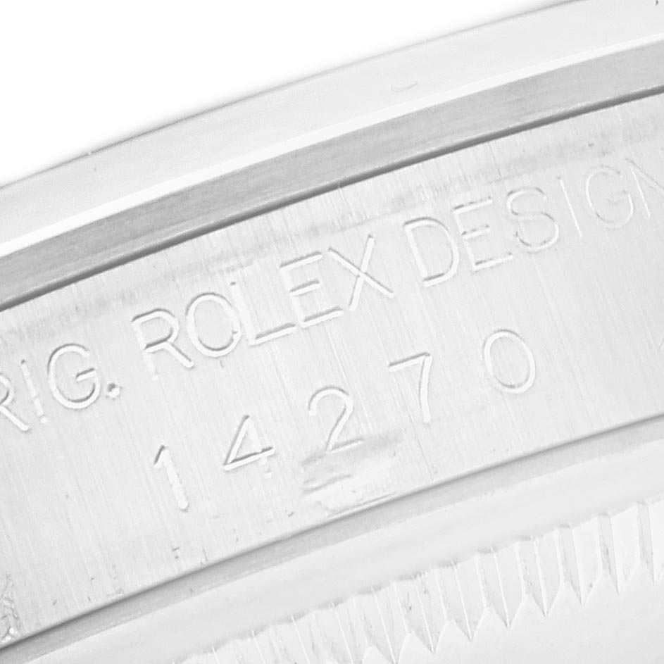 The image shows a close-up of the serial engraving on the side of the Rolex Explorer 14270 Men's Stainless Steel Black Dial 14270 Men's Stainless Steel Black Dial watch.