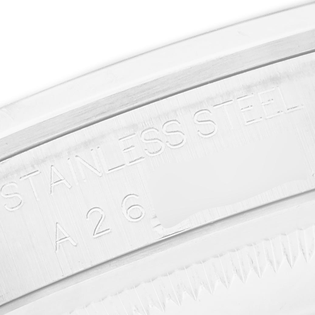 The image shows a close-up of the Rolex Explorer 14270 Men's Stainless Steel Black Dial 14270 Men's Stainless Steel Black Dial's stainless steel casing with engraved text.