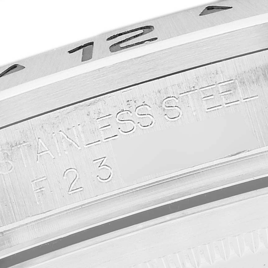 The image shows a close-up view of the edge of the bezel and case back of a Rolex Explorer 16570 Men
s Stainless Steel Black Dial 16570 Men
s Stainless Steel Black Dial watch, focusing on the engravings.