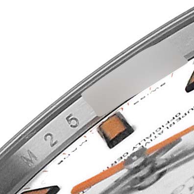This image shows a close-up of the bezel and part of the dial of a Rolex Milgauss 116400 Men's Stainless Steel White Dial 116400 Men's Stainless Steel White Dial watch, highlighting the minute markers and orange hour markers.